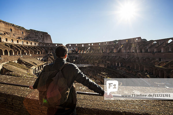 'A male tourist stands looking at the Colosseum; Rome  Italy'