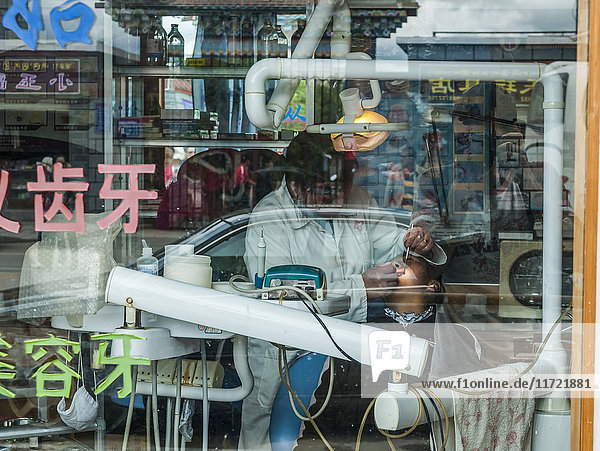 'A dentist visit in Shangrila city not very private and everyone can see you from the window of the dental office; Shangrila Yunnan province. China'