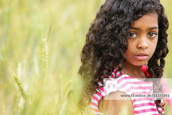 'Portrait of a young girl with dark  curly hair and big brown eyes; Vancouver  Washington  United States of America'