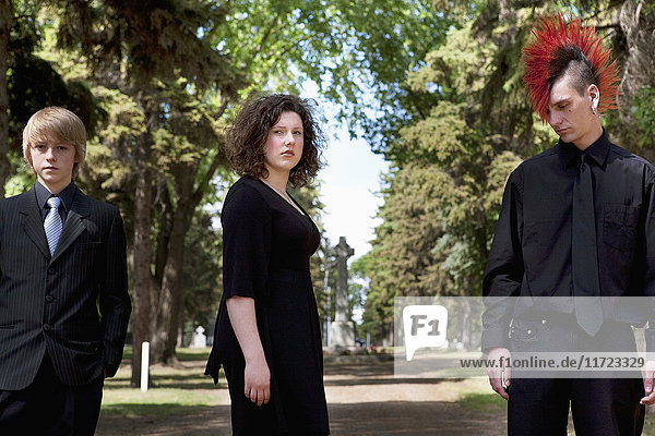 'Three Young People In A Cemetery; Edmonton  Alberta  Canada'