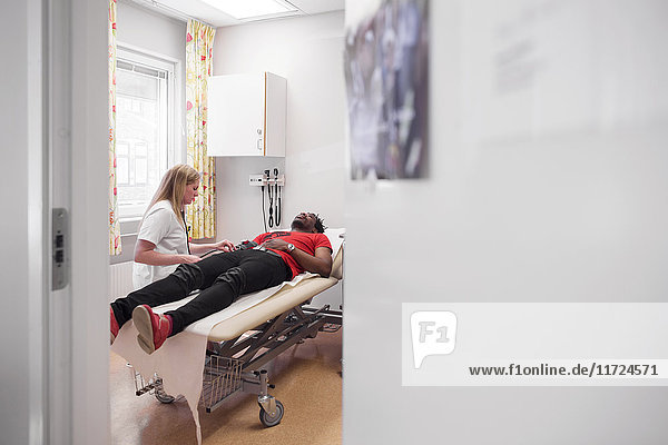 Young man with doctor during medical procedure