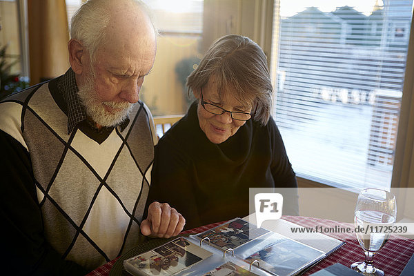Old couple looking at photos