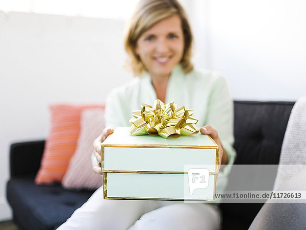 Mature woman giving gift