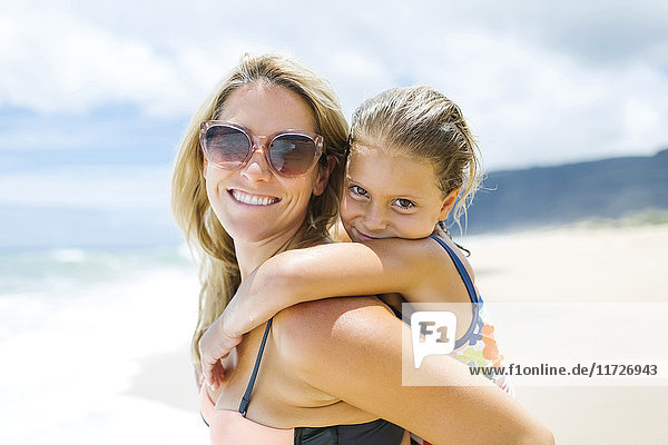 USA  Hawaii  Kauai  Mother with daughter (6-7) playing on beach