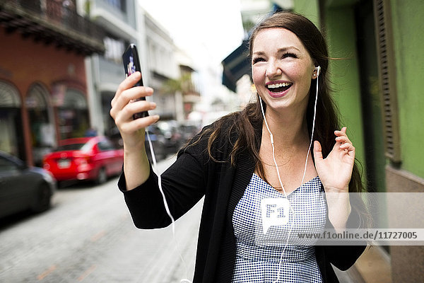 Puerto Rico  San Juan  Woman listening to music on street