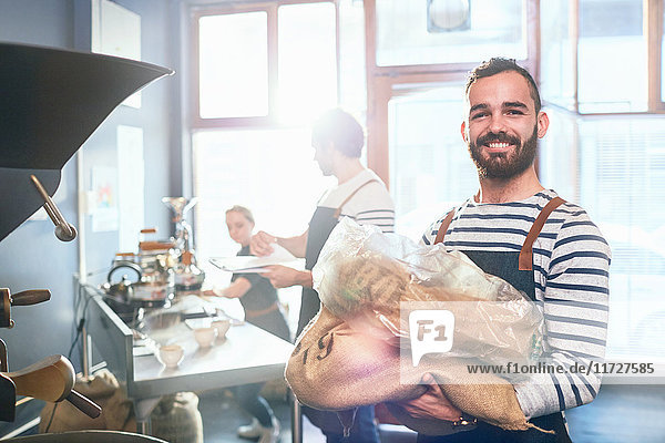 Portrait smiling  confident male coffee roaster