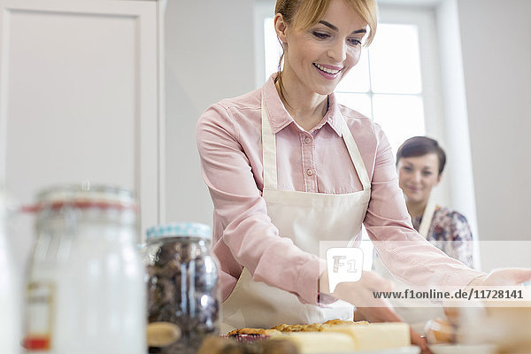 Smiling woman baking in kitchen