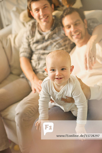 Portrait cute baby son with male gay parents
