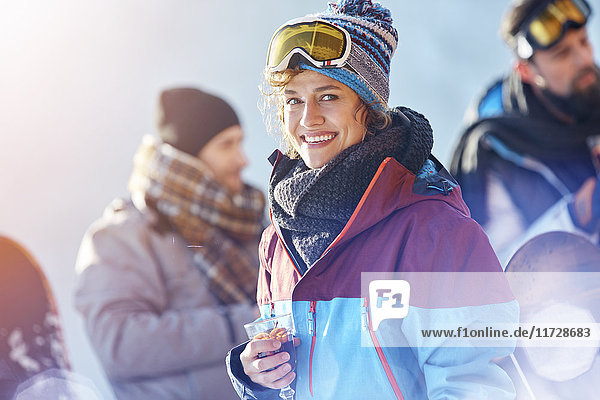 Portrait lächelnde Skifahrerin trinkt Cocktail