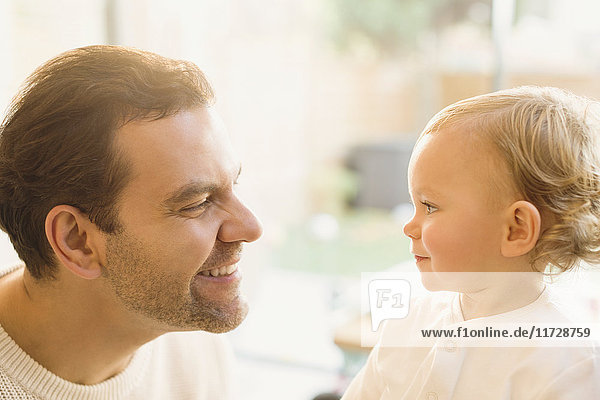 Father smiling at cute baby son