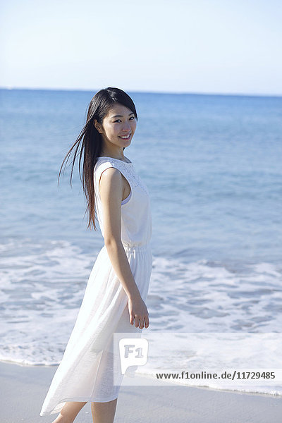 Young Japanese woman in a white dress by the sea  Chiba  Japan