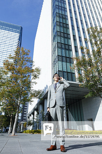 Japanese businessman on the phone downtown Tokyo  Japan