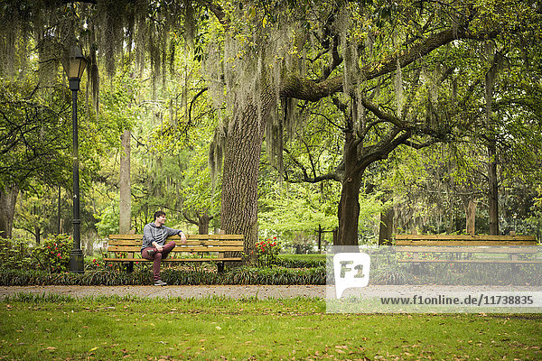 Man on park bench  Savannah  Georgia  USA