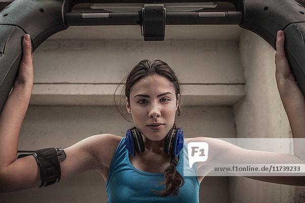 Young woman using gym equipment  portrait