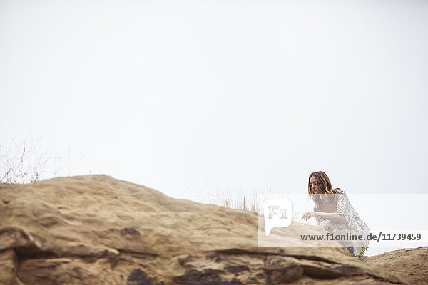 Woman relaxing on rock formation  Stoney Point  Topanga Canyon  Chatsworth  Los Angeles  California  USA