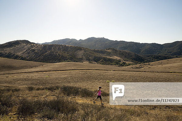 Mature female runner running through landscape  Thousand Oaks  California  USA