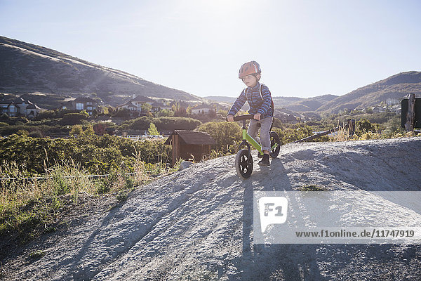 Boy going down hill on balance bike  Draper cycle park  Missoula  Montana  USA