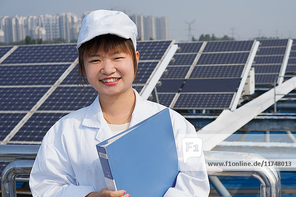 Female worker on roof of solar panel assembly factory  Solar Valley  Dezhou  China