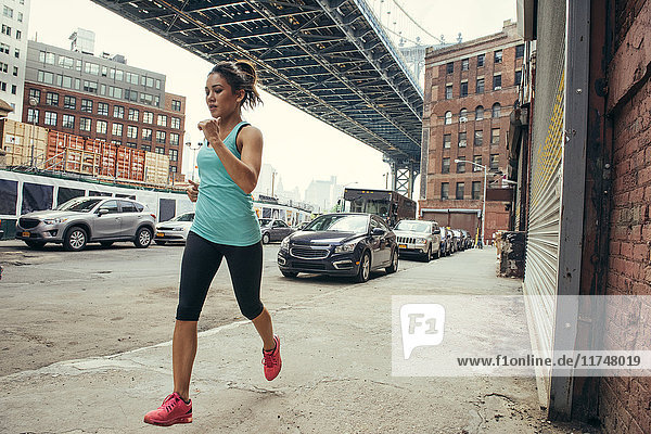 Young female runner running New York USA