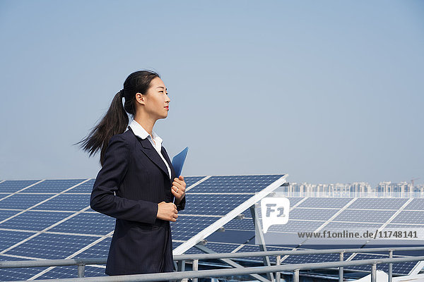 Businesswoman on roof of solar panel assembly factory  Solar Valley  Dezhou  China