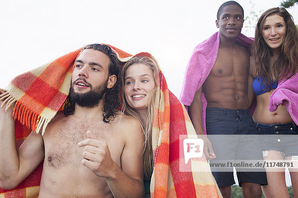 Couples relaxing on beach