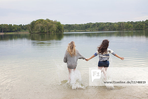 Young women playing in lake