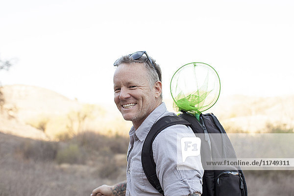 Candid portrait of smiling male hiker