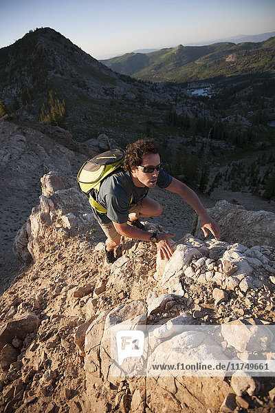 Hiker climbing  Sunset Peak trail  Catherine's Pass  Wasatch Mountains  Utah  USA