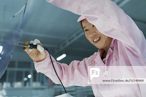 Female worker in solar panel assembly factory  Solar Valley  Dezhou  China
