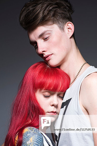Young couple embracing in studio