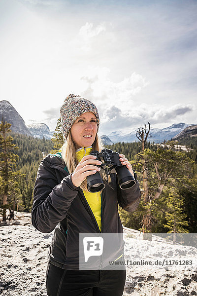 Woman holding binoculars  Yosemite National Park  California  USA
