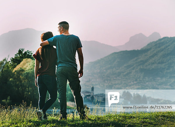 Couple standing in rural setting  looking at view  rear view