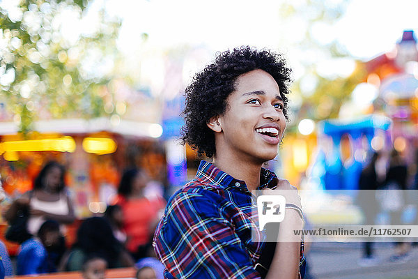 Portrait of teenage boy at funfair  smiling