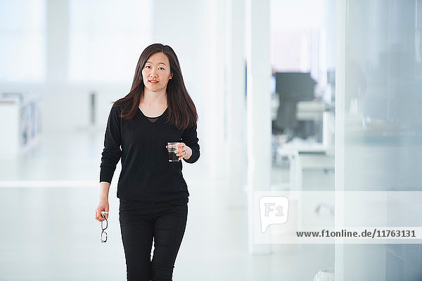 Portrait of businesswoman in office looking at camera
