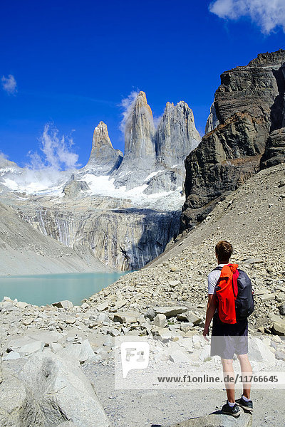Hiker in front of the rock towers that give the Torres del Paine range its name  Torres del Paine National Park  Patagonia  Chile  South America