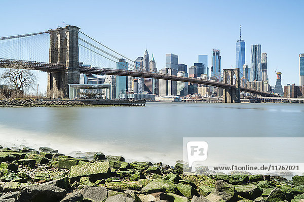 Brooklyn Bridge and Lower Manhattan skyline viewed from Brooklyn side of East River  New York City  United States of America  North America