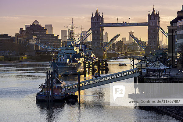 Tower Bridge raising deck with HMS Belfast on the River Thames  London  England  United Kingdom  Europe