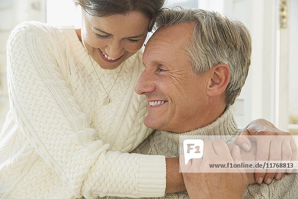 Close up affectionate mature couple hugging and smiling