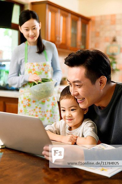 Father and daughter watching laptop
