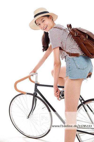 Young woman riding bicycle