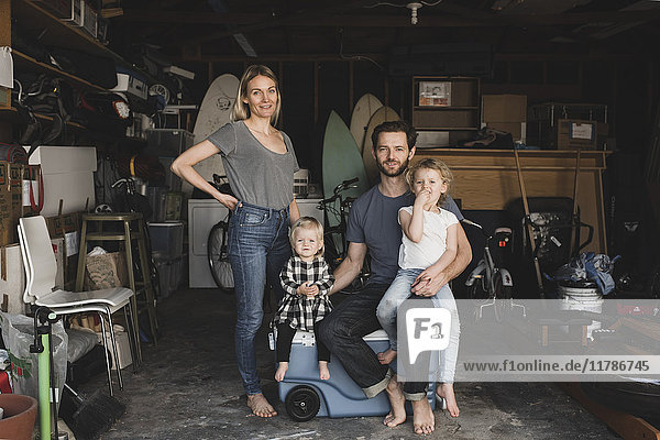 Portrait of parents and children in storage room of house