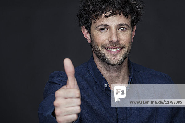 Man giving thumbs up and smiling  portrait