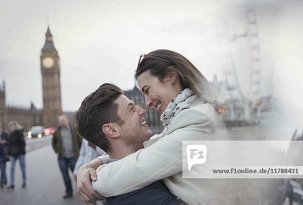 Romantic  affectionate couple tourists hugging near Big Ben  London  UK