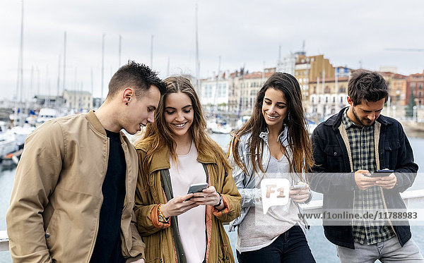 Group of friends sending messages with the smartphone