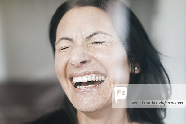 Portrait of laughing woman with eyes closed