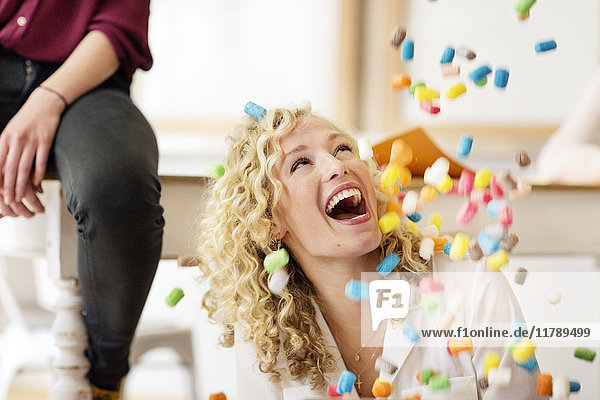 Blond businesswoman laughing about falling marshmellows