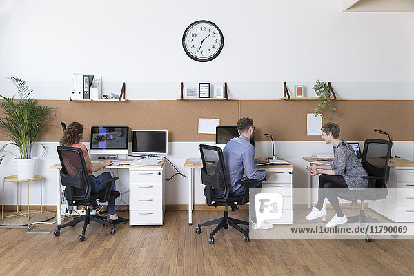 Colleagues working in modern office