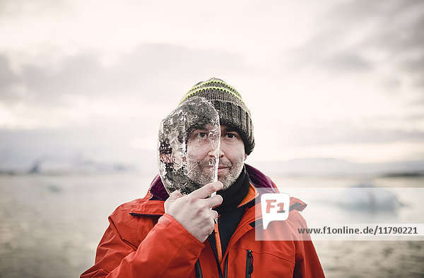 Iceland  man with a piece of ice covering half of his face