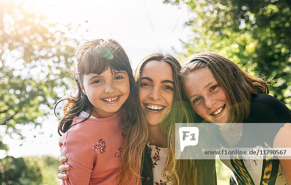 Portrait of three happy girls outdoors