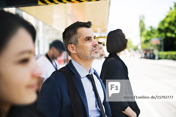 Businessman waiting at the bus stop